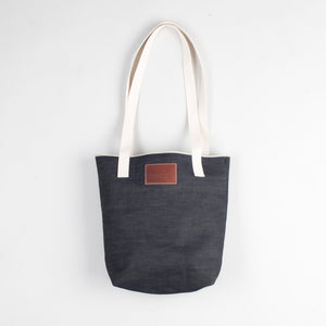 angle: denim | Raleigh Denim Workshop denim tote bag with cream handles and leather patch