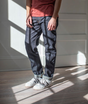 angle hover: 211 | A model wears Raleigh Denim Workshop Jones thin fit selvage raw jeans, front view
